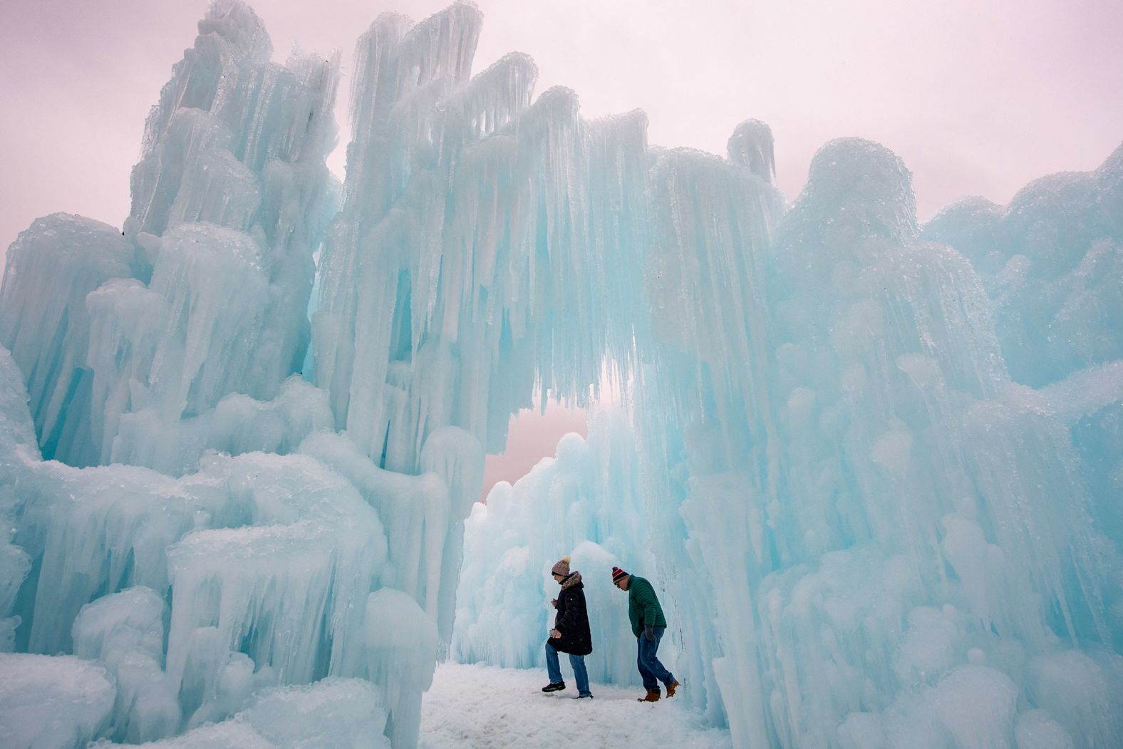 People explore the ice walls, trails and caverns at the Ice Castles tourist attraction in North Woodstock, New Hampshire, on Thursday, February 1.