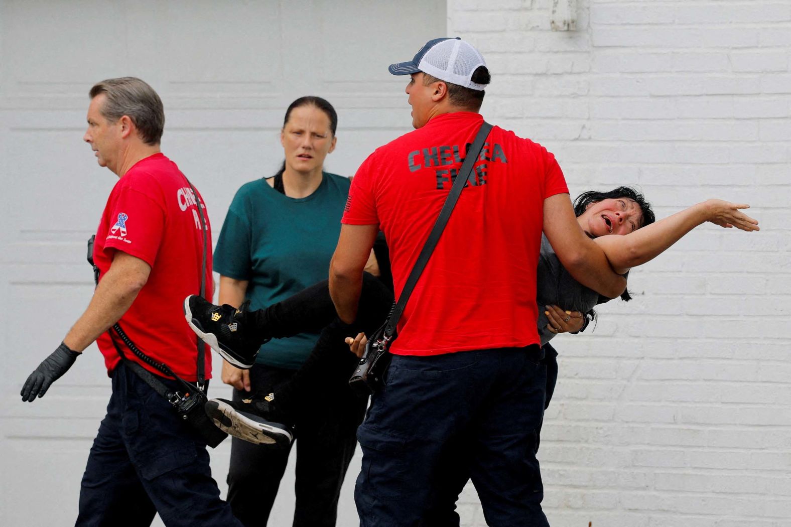 A woman is carried to an ambulance after witnesses say she was thrown to the ground while being detained by federal agents during an immigration raid in Chelsea, Massachusetts, on Friday, September 26. The agents released the woman at the scene after finding out she is a legal permanent resident, <a href="index.php?page=&url=https%3A%2F%2Fwww.reuters.com%2Fworld%2Fus%2Fice-tactics-inflame-tensions-new-york-chicago-other-cities-2025-09-26%2F" target="_blank">Reuters reported</a>.