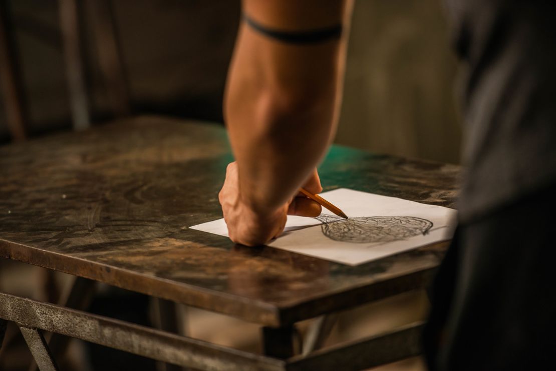 Beltrami sketches an idea for a glass vase at his workshop in Murano.