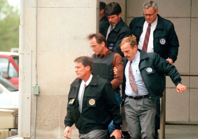Suspect Terry L. Nichols, wearing a bulletproof vest, is escorted by US marshals as he leaves a federal courthouse in Wichita, Kansas, on April 26, 1995.