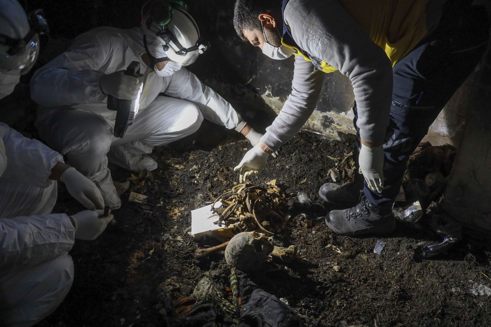 Syrian civil defense workers known as the White Helmets collect human remains found in two separate basements in Sbeneh, Syria, on Tuesday, January 28. They said the charred remains belong to at least 26 victims of the Bashar al-Assad regime. Since Assad fled the country on December 8 following the collapse of his regime, Syrians are starting to uncover <a href="index.php?page=&url=https%3A%2F%2Fwww.cnn.com%2F2024%2F12%2F17%2Fmiddleeast%2Fsyria-assad-regime-mass-graves-intl%2Findex.html">mass graves across the country</a>.