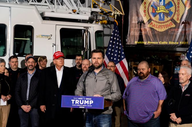 Vance, with Trump behind him, speaks to the media at the East Palestine Fire Department station in East Palestine, Ohio, in February 2023. A train carrying hazardous materials, including the toxic chemical vinyl chloride, had derailed in East Palestine, and <a href="https://www.cnn.com/2023/02/08/us/east-palestine-ohio-train-derailment-fire-wednesday/index.html">the wreckage burned for days</a>.