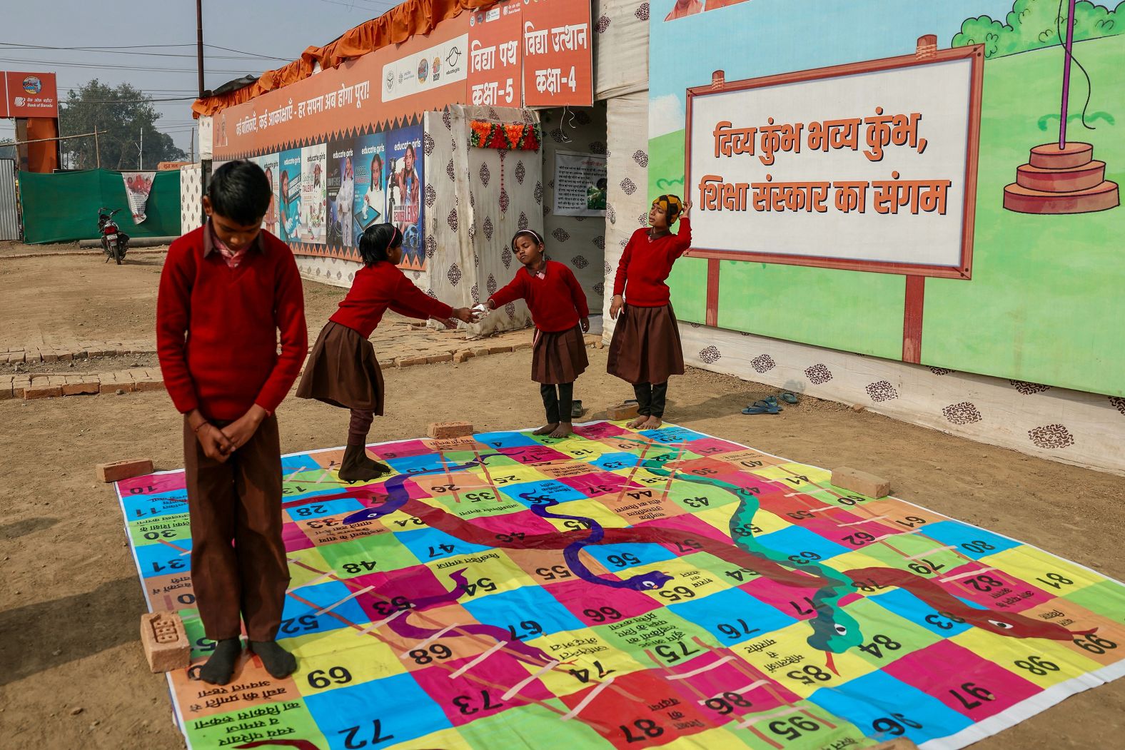 Children play outside a makeshift school ahead of the <a href="index.php?page=&url=https%3A%2F%2Fwww.cnn.com%2F2025%2F01%2F12%2Ftravel%2Findia-maha-kumbh-mela-2025-intl-hnk%2Findex.html">Maha Kumbh Mela festival </a>in Prayagraj, India, on Saturday, January 11.