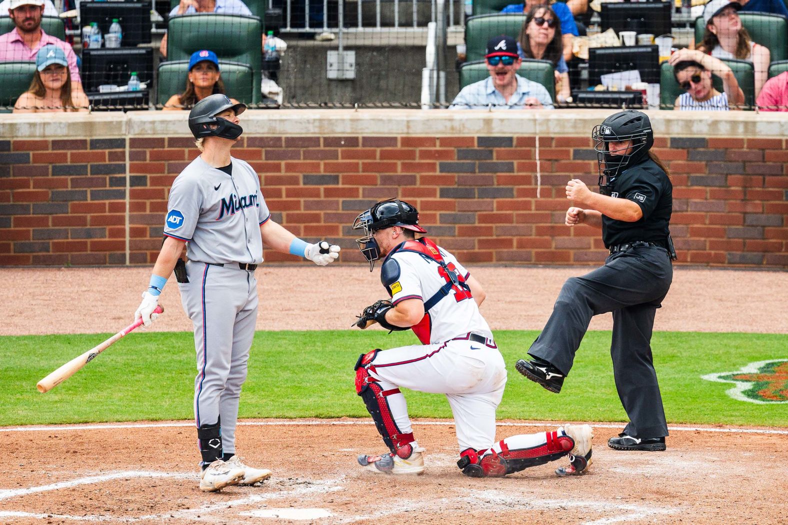 Miami outfielder Kyle Stowers, left, objects to a call made by umpire <a href="index.php?page=&url=https%3A%2F%2Fwww.cnn.com%2F2025%2F08%2F09%2Fsport%2Fbaseball-mlb-jen-pawol-first-female-umpire-spt">Jen Pawol</a> during a Major League Baseball game in Atlanta on Sunday, August 10. The day before, Pawol made history by becoming the first woman to umpire a Major League Baseball regular season game.