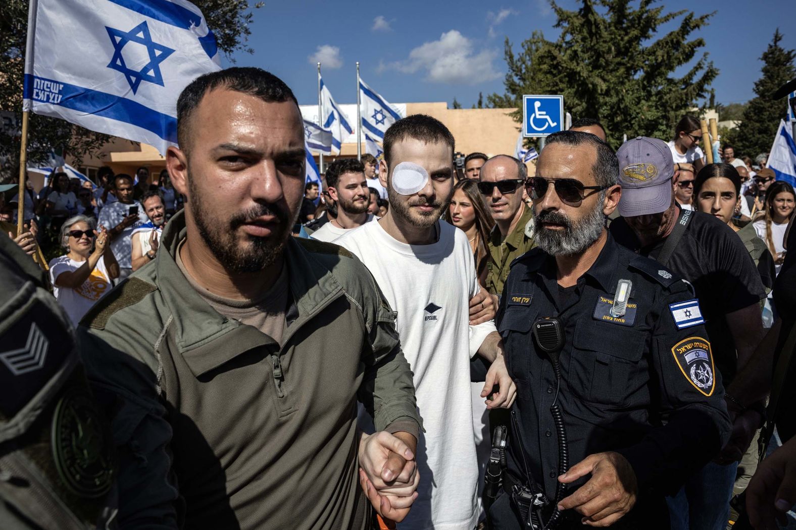 Alon Ohel, center, is cheered by well-wishers as he returns home to Lavon, Israel, after his release from the hospital on Friday, October 24. Ohel was among those kidnapped by Hamas on October 7, 2023. He spent more than two years in captivity.