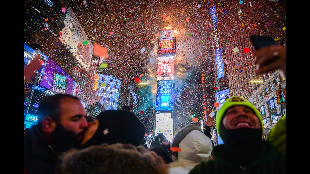 Confetti falls over the crowd as the clock strikes midnight at Times Square in New York.