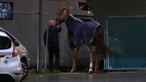 A horse is led away during the Liverpool International Horse Show held at the Echo Arena following a blaze at a multi-storey car park nearby.