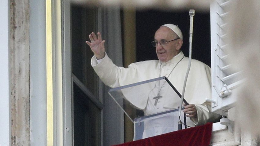 Pope Francis salutes the faithful as he recites the first Angelus prayer of the new year from his studio overlooking St. Peter's square at the Vatican, Monday, Jan. 1, 2018. Francis told people in St. Peter's Square that all must work to secure a future of peace, including for migrants.