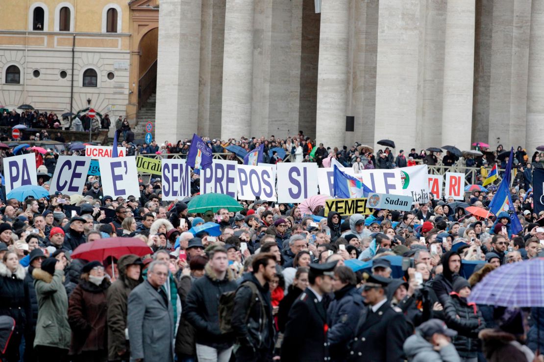 Faithful held placards reading "Pace e' semipro possible" (Peace is always possible) on Monday.