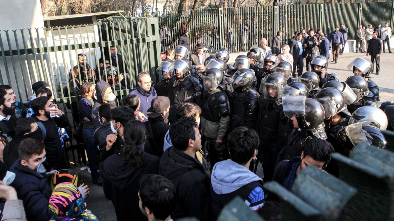Iranian students scuffle with police at the University of Tehran during a December 30 protest.
