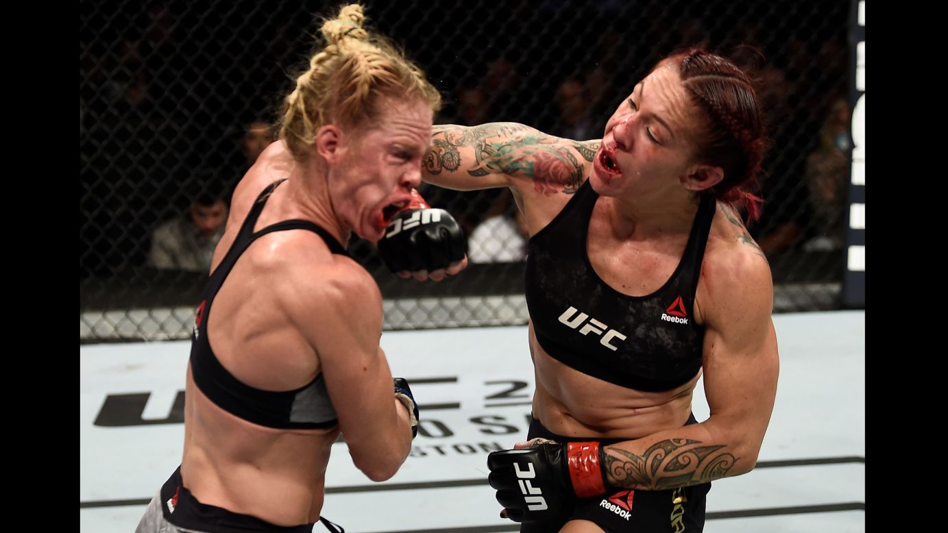 Cris Cyborg punches Holly Holm during their UFC title fight in Las Vegas on Saturday, December 30. Cyborg won a unanimous decision to retain her featherweight championship.