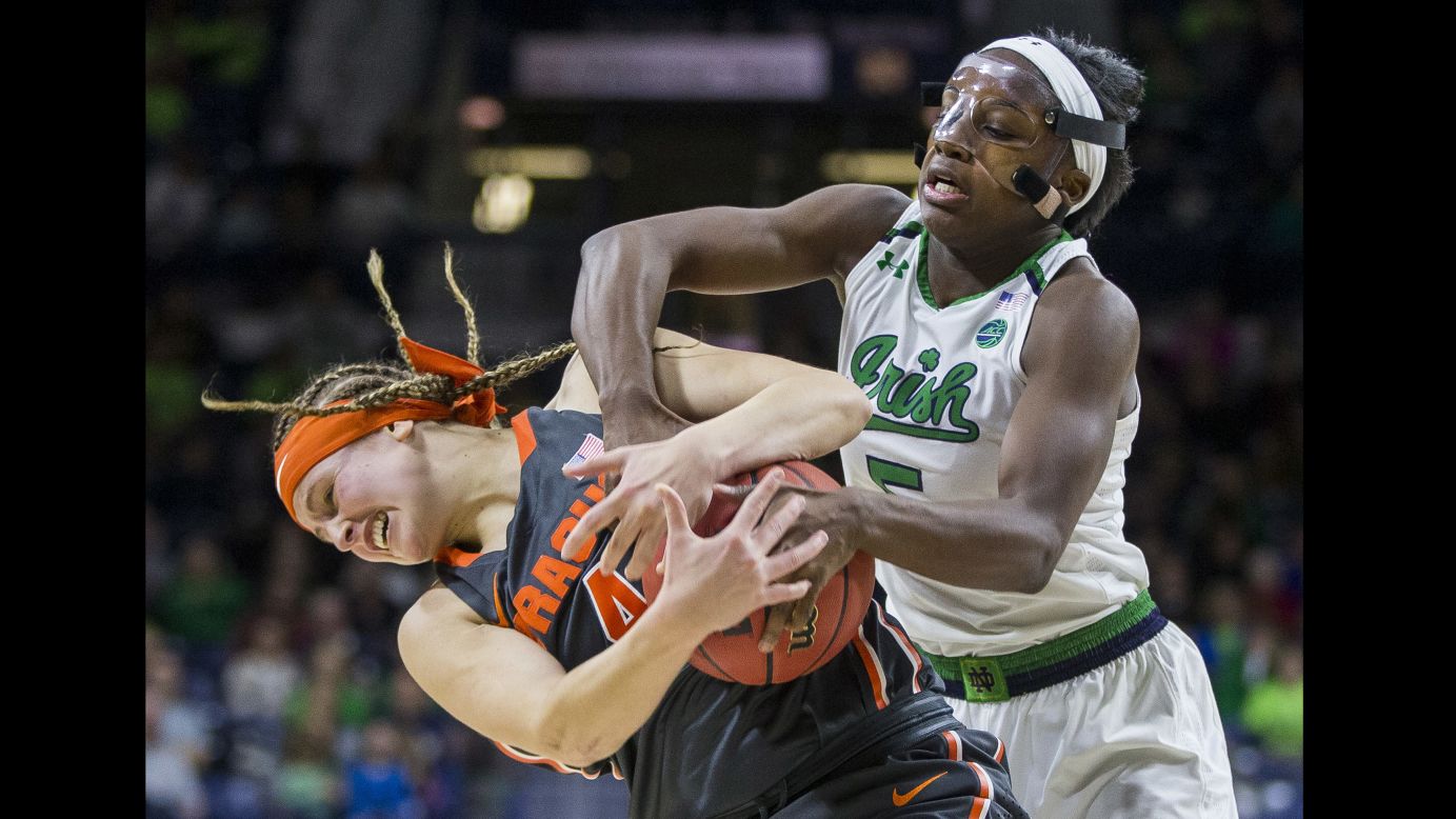Syracuse's Tiana Mangakahia, left, wrestles for the ball with Notre Dame's Jackie Young during a college basketball game in South Bend, Indiana, on Thursday, December 28.