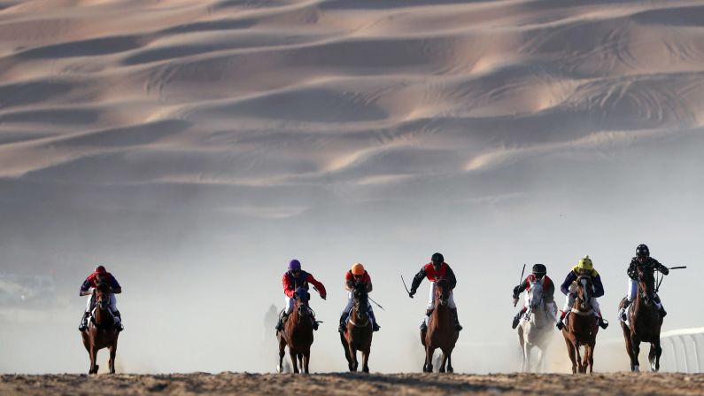 Horses race in the United Arab Emirates' Liwa desert during the Moreeb Dune Festival on Monday, January 1.