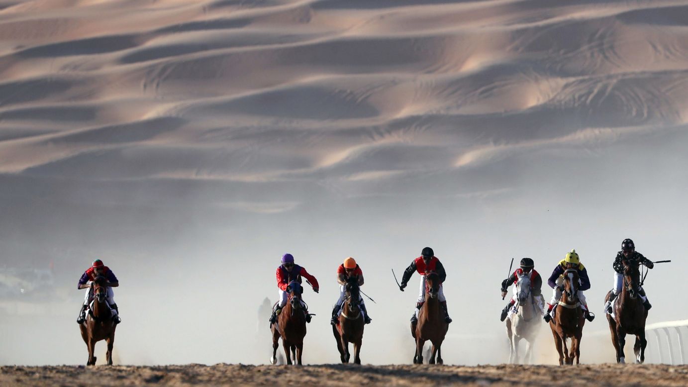 Horses race in the United Arab Emirates' Liwa desert during the Moreeb Dune Festival on Monday, January 1.