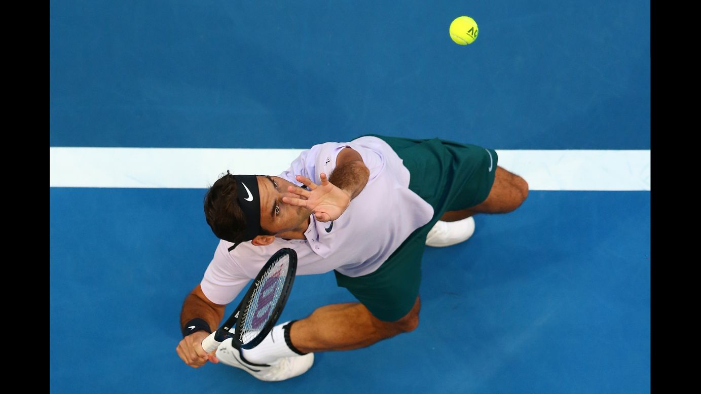 Roger Federer serves to Yuichi Sugita during a Hopman Cup match in Perth, Australia, on Saturday, December 30. Federer and the Swiss team defeated Sugita and the Japanese team 3-0.