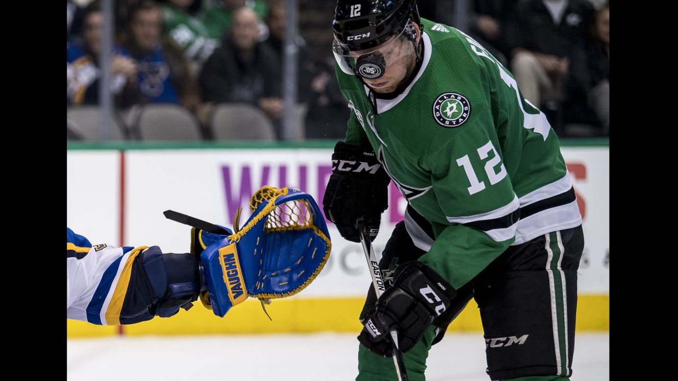 The puck bounces off the visor of Dallas center Radek Faksa during an NHL game on Friday, December 29.