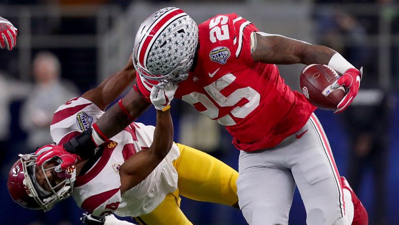 Ohio State running back Mike Weber stiff-arms USC's Isaiah Langley during the Cotton Bowl Classic on Friday, December 29. Ohio State won 24-7 in what was a matchup of two conference champions.