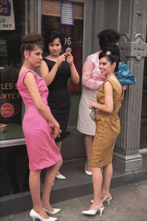 Joel Meyerowitz, a pioneer of color photography. Reminiscing about this shot from in the early '60s, he said: "The four girls stood in a doorway primping and getting ready to walk in the parade. Seen against the dreary buildings, they were like tropical flowers bursting into color."