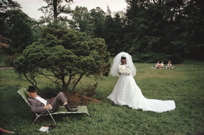 "Walking through the gardens one summer Saturday, I saw a bride posing for her wedding album. But, at the same time, I saw what the wedding photographer would cut out of his frame: the man sitting on his lounge chair. I knew right then that the photograph was about that." 