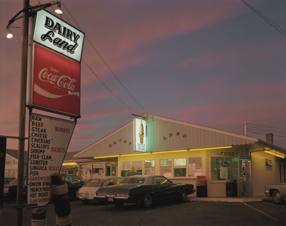 "I was on my way back from the supermarket when I passed Dairy Land," Meyerowitz said. Out of the corner of my eye, the neon glow called out to me, so I swerved right in. Stepping out of the car was like stepping into a cotton-candy pink haze. The light radiating through and off the clouds at that hour suffused everything with a rosy glow against which the yellow neon hummed a crazy harmony." 