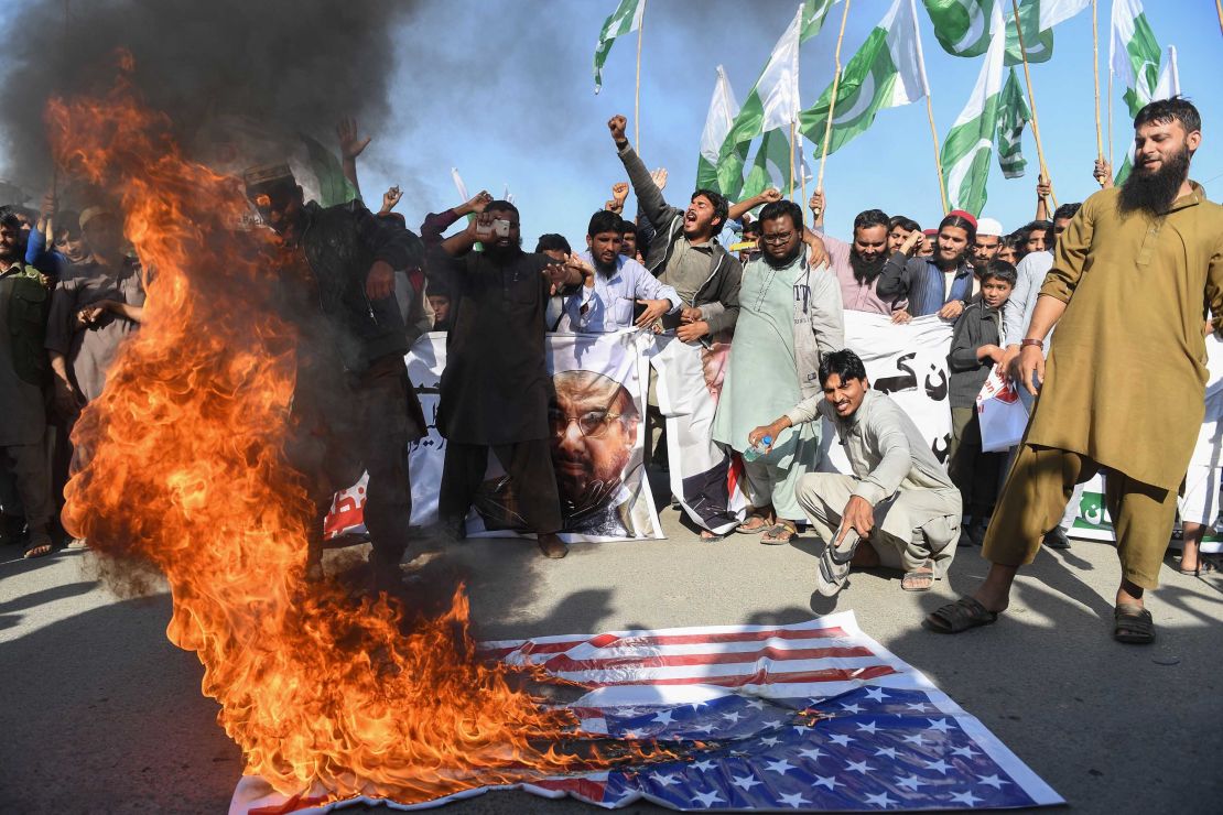 Activists burn the American flag at a protest in Karachi on Tuesday. 