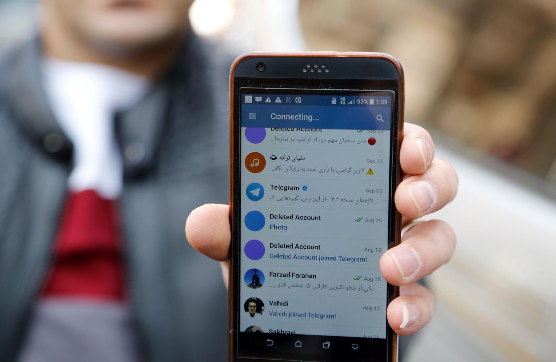 An Iranian man shows his phone as certain apps were restricted in Tehran on Tuesday.