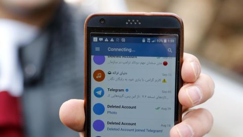 An Iranian man shows his phone as certain apps were restricted in Tehran on Tuesday. 