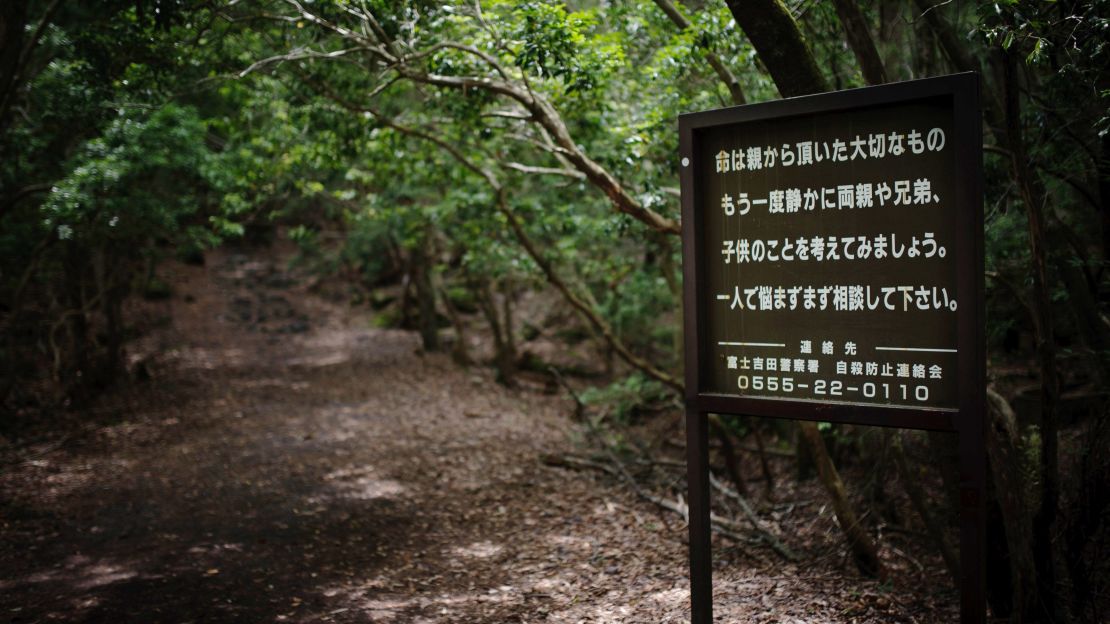 A sign at the entrance of the Aokigahara forest urges suicidal visitors to reach out for help.
