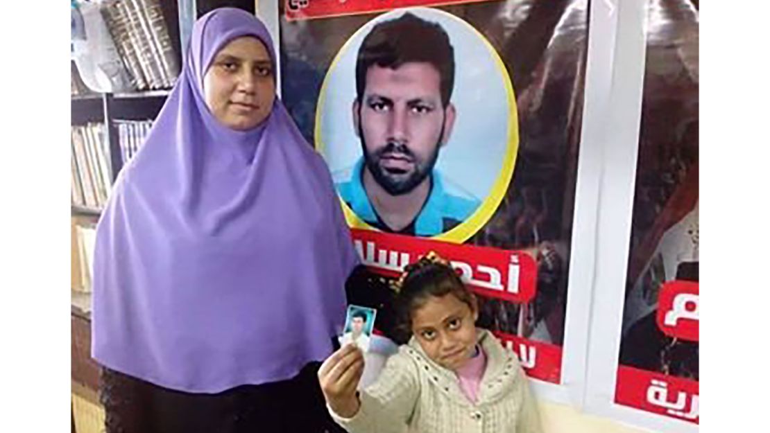 Ahmed Salama's wife and daughter are pictured in an undated image in Cairo. They are standing in front of a sign with Salama's image. Salama was  executed this week. 