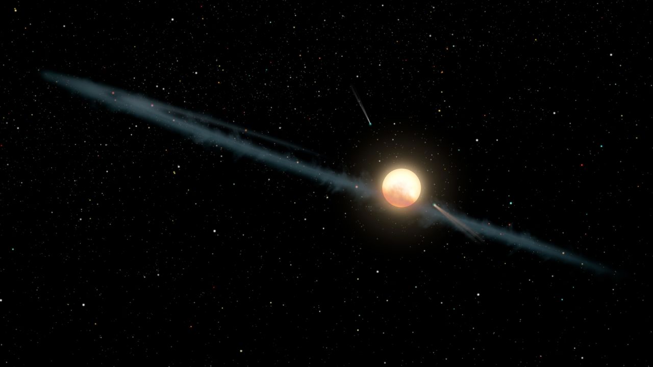 KIC 8462852, also known as Boyajian's Star or Tabby's Star, is 1,000 light-years from us. It's 50% bigger than our sun and 1,000 degrees hotter. And it doesn't behave like any other star, dimming and brightening sporadically. Dust around the star, depicted here in an artist's illustration, may be the most likely cause of its strange behavior.