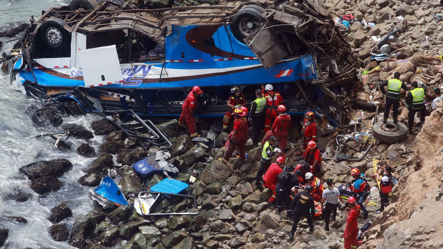 Rescue personnel work at the site of a bus accident north of Lima, capital of Peru, on Tuesday.