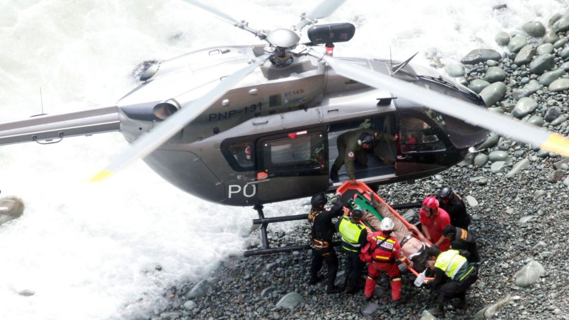 Rescue personnel transfer an injured person to a helicopter after the accident. 