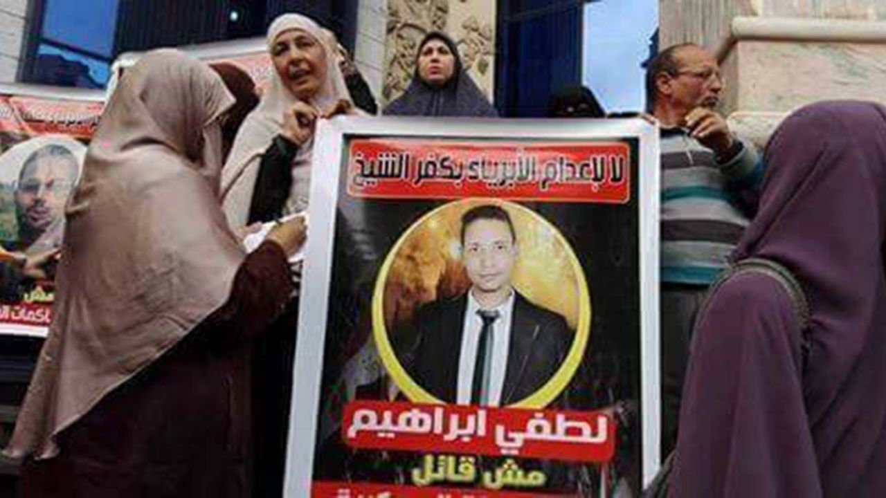 Protesters gathered outside  a court building in Cairo in 2017 hold a sign saying "Do not execute the innocents of Kafr el-Sheikh. Lotfy Ibrahim (Khalil) is not a killer." 