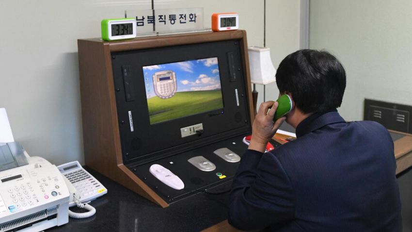 A South Korean government official communicates with a North Korean officer during a phone call on the dedicated communications hotline at the border village of Panmunjom in Paju, South Korea, Wednesday, Jan. 3, 2018. North Korean leader Kim Jong Un reopened a key cross-border communication channel with South Korea on Wednesday, another sign easing animosity between the rivals even as Kim traded combative threats of nuclear war with President Donald Trump. (Yonhap via AP)