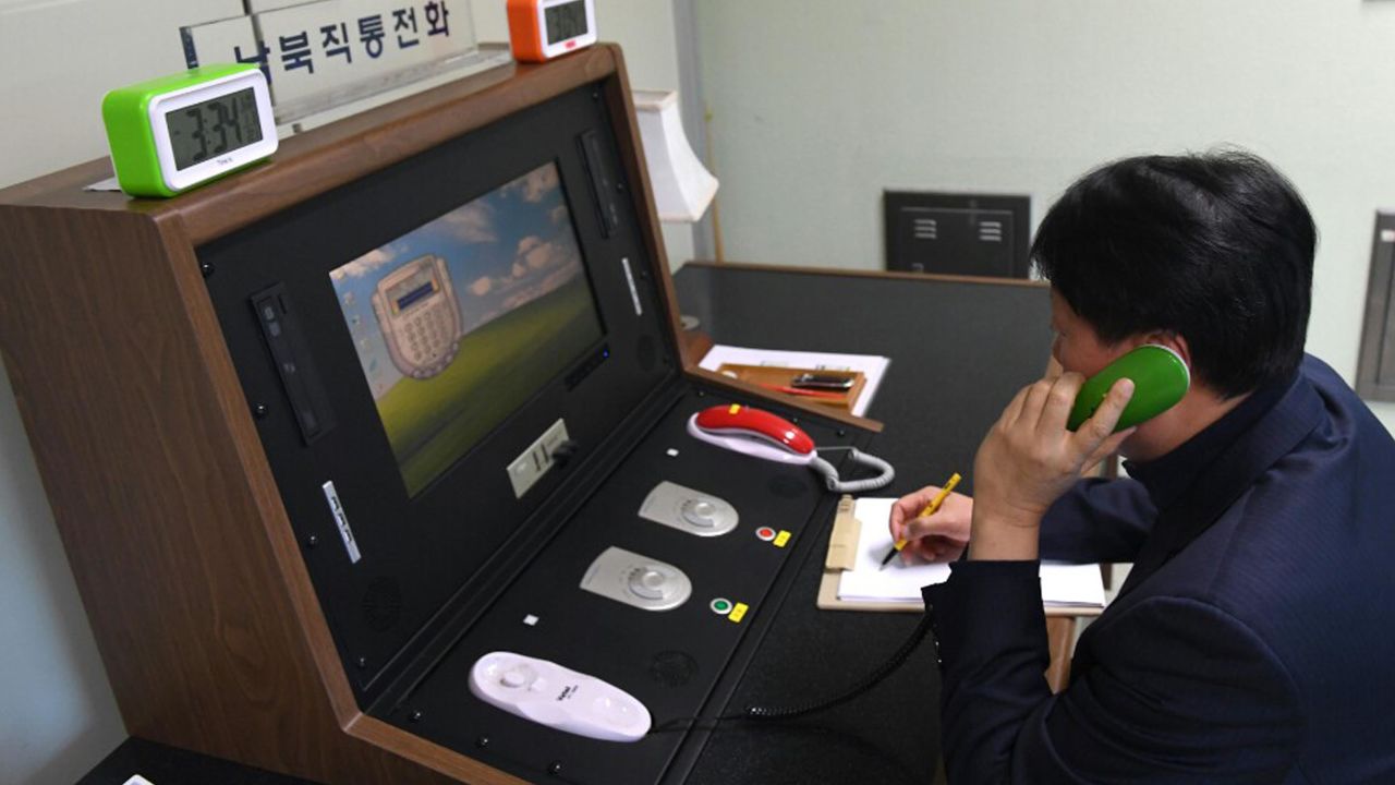 A South Korean government official communicates with a North Korean officer during a phone call on the dedicated communications hotline at the border village of Panmunjom in Paju, South Korea, Wednesday, Jan. 3, 2018. North Korean leader Kim Jong Un reopened a key cross-border communication channel with South Korea on Wednesday, another sign easing animosity between the rivals even as Kim traded combative threats of nuclear war with President Donald Trump. (Yonhap via AP)