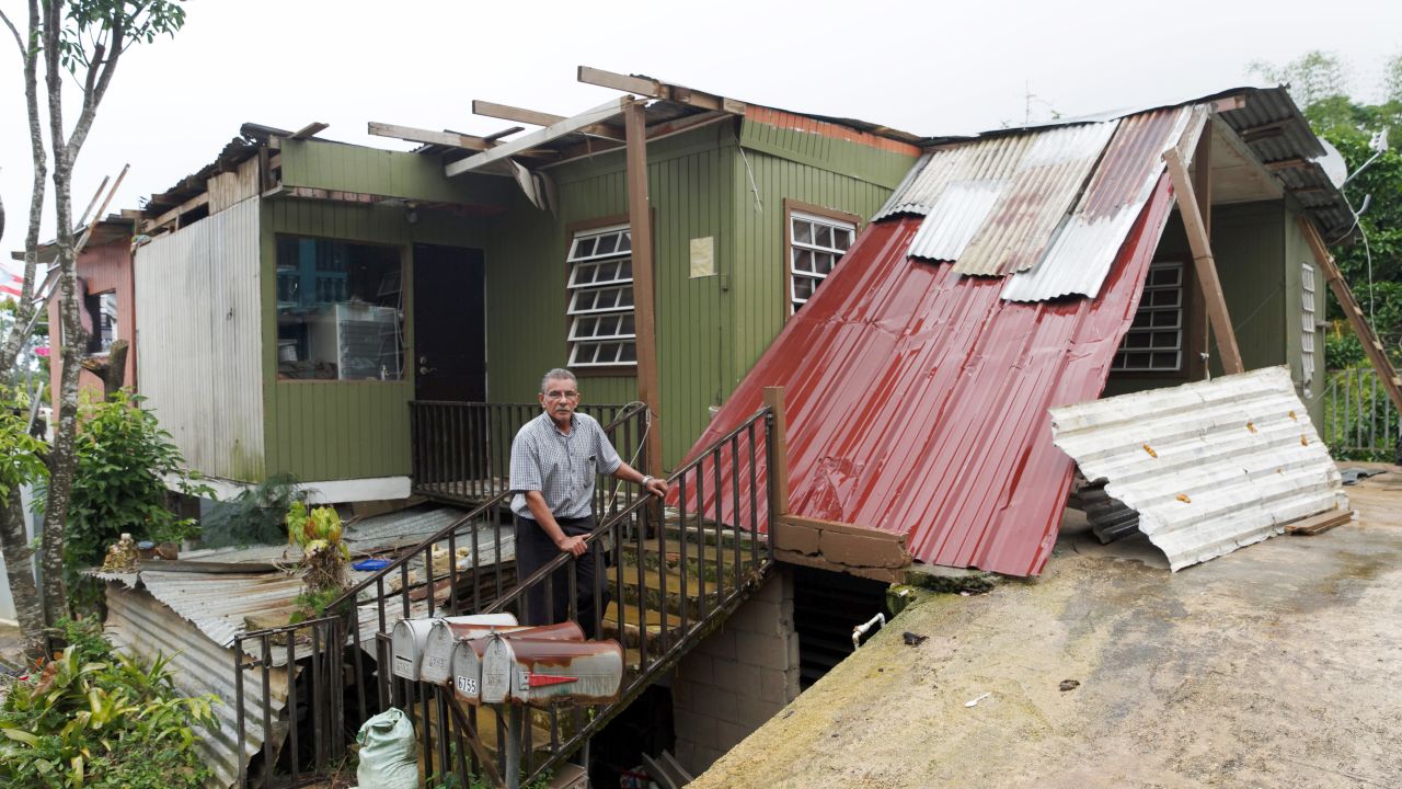 Three months after the storm, Manuel Morales still lives in an ad hoc shelter with his wife.