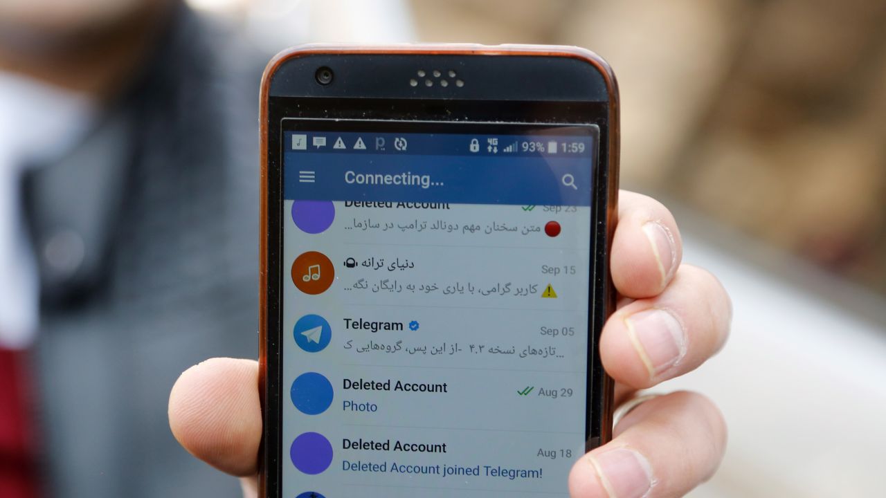 An Iranian man shows his phone as certain apps were restricted in Tehran on Tuesday.
