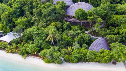 Bawah Island's bamboo bungalows peek through the jungle.