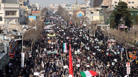 Iranian pro-government supporters march in the city of Mashhad on Thursday.