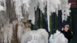 NEW YORK, NY - JANUARY 03: A woman photographs a frozen fountain in Bryant Park, January 3, 2018 in New York City. New York City was placed under a winter storm watch Wednesday as a major weather system is expected to threaten the area with heavy snow and powerful wind Wednesday night into Thursday. (Photo by Drew Angerer/Getty Images)