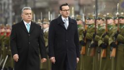 Staying on an official visit in Hungary new Polish Prime Minister Mateusz Morawiecki, right, and his Hungarian counterpart Viktor Orban inspect the honour guards during the welcoming ceremony in front of the parliament building in Budapest, Hungary, Wednesday, Jan. 3, 2018. (Tamas Kovacs/MTI via AP)