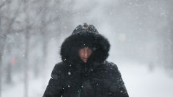 A man walks through the streets of Boston as the snow begins to fall from a massive winter storm on January 4 in Boston, Massachusetts. Schools and businesses throughout the Boston area are closed as the city is expecting over a foot of snow and blizzard like conditions throughout the day.