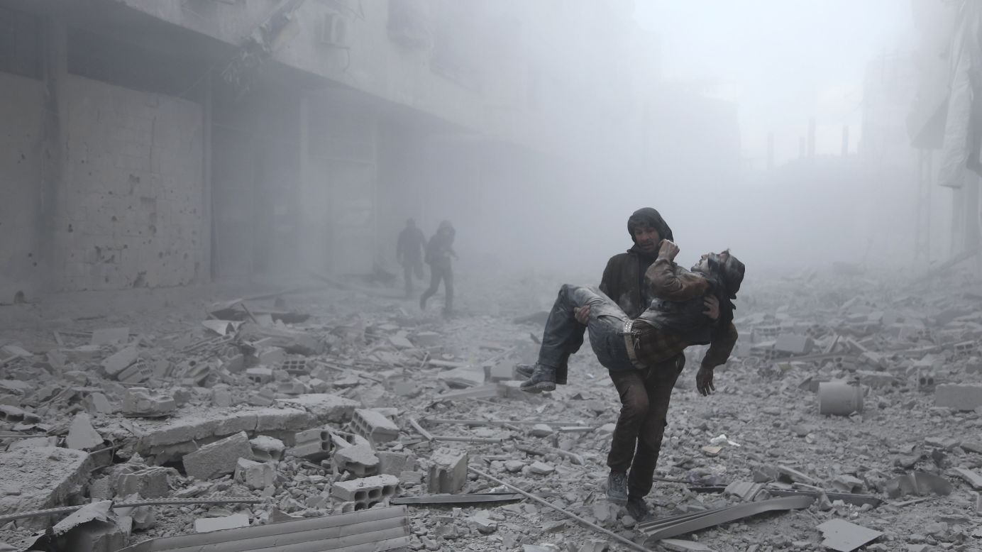 A wounded man is carried away after an airstrike on the rebel-held town of Arbin, Syria, on Tuesday, January 2. Syria's civil war has been going on since 2011.