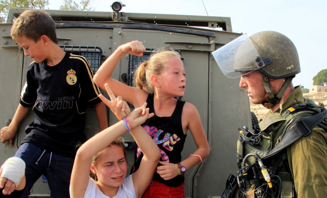 Ahed Tamimi (C) challenges Israeli soldiers during a protest in Ramallah in November 2012.