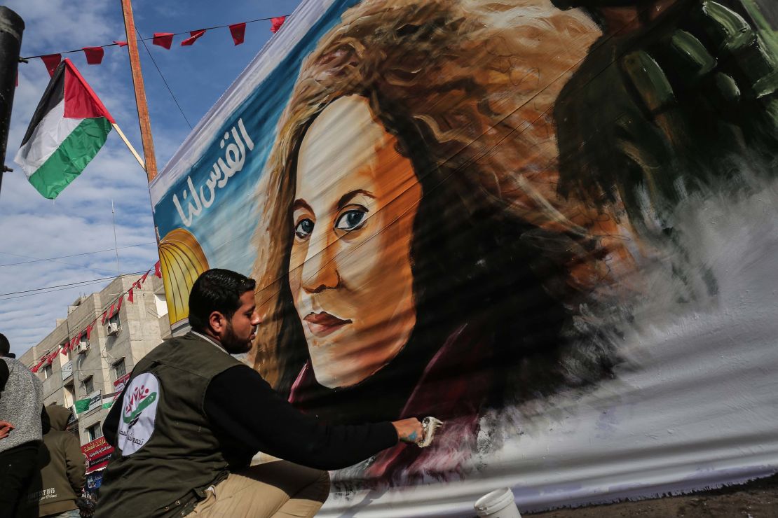 A Palestinian artist paints a portrait of Ahed Tamimi in Gaza on Wednesday.