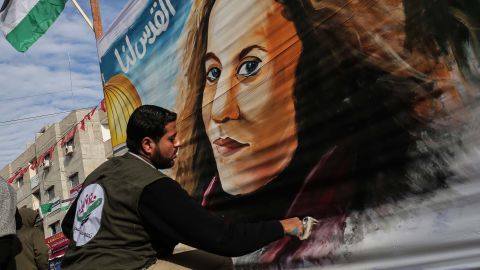 A Palestinian artist paints a portrait of Ahed Tamimi in Gaza on Wednesday.