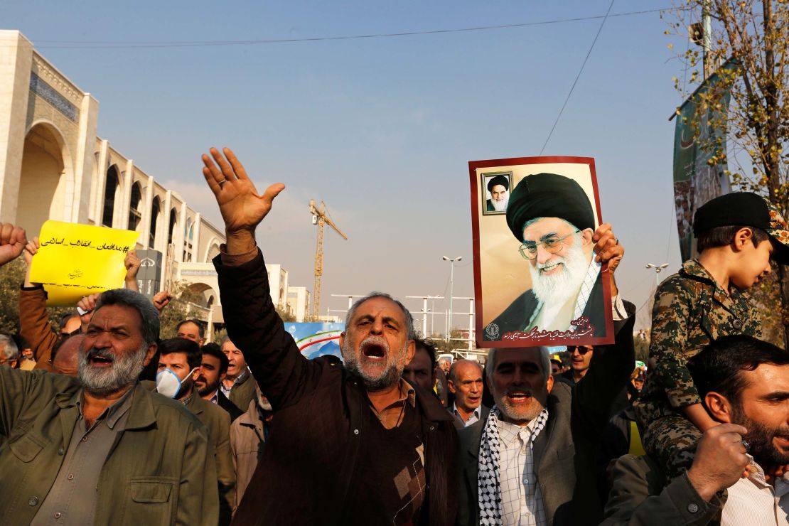 Government supporters  march following prayers Friday in Tehran.