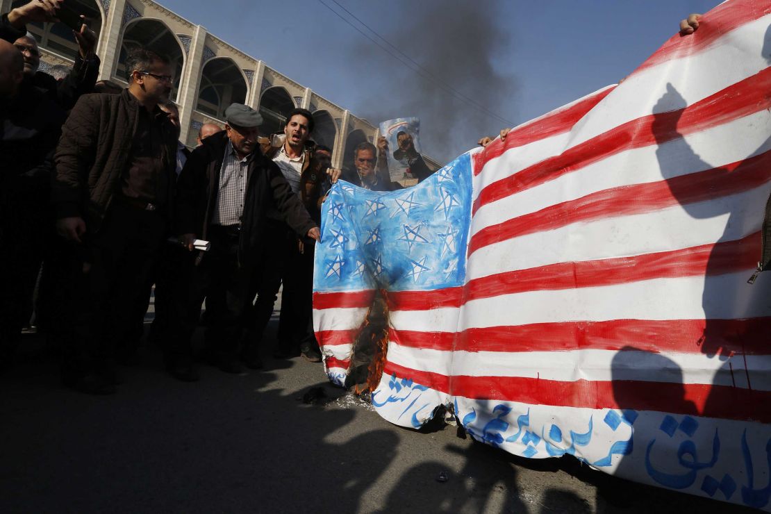 Iranian pro-government demonstrators set fire to a makeshift US flag during a march after Friday prayers in Tehran.