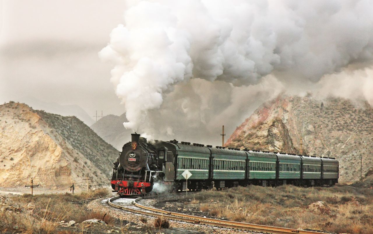 <strong>China's spectacular steam trains: </strong>British photographer David Kitching has spent the past twenty years taking stunning photographs of China's steam trains, including this 2009 image of the morning passenger service to Shenbutong copper mine -- with a plaque on the front celebrating the Beijing Olympics. Kitching's photos are the subject of a new book: "<a href="https://www.amberley-books.com/chinese-steam.html" target="_blank" target="_blank">Chinese Steam: The Last Years</a>", published by <a href="https://www.amberley-books.com/" target="_blank" target="_blank">Amberley Books</a>.