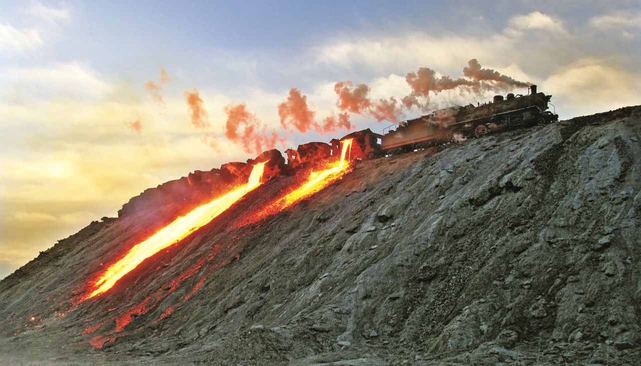 <strong>Welcome reception:</strong> Kitching has fond memories of all his travels. "The train crews made us welcome," he says. This 2006 photograph shows the large slag banks at Baotou and the slag being tipped from the pots. 